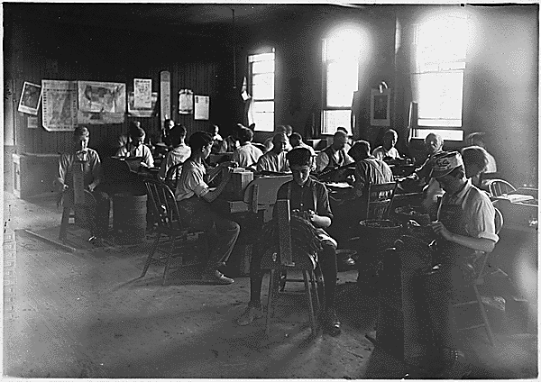  young children at work in an early 20th century factory