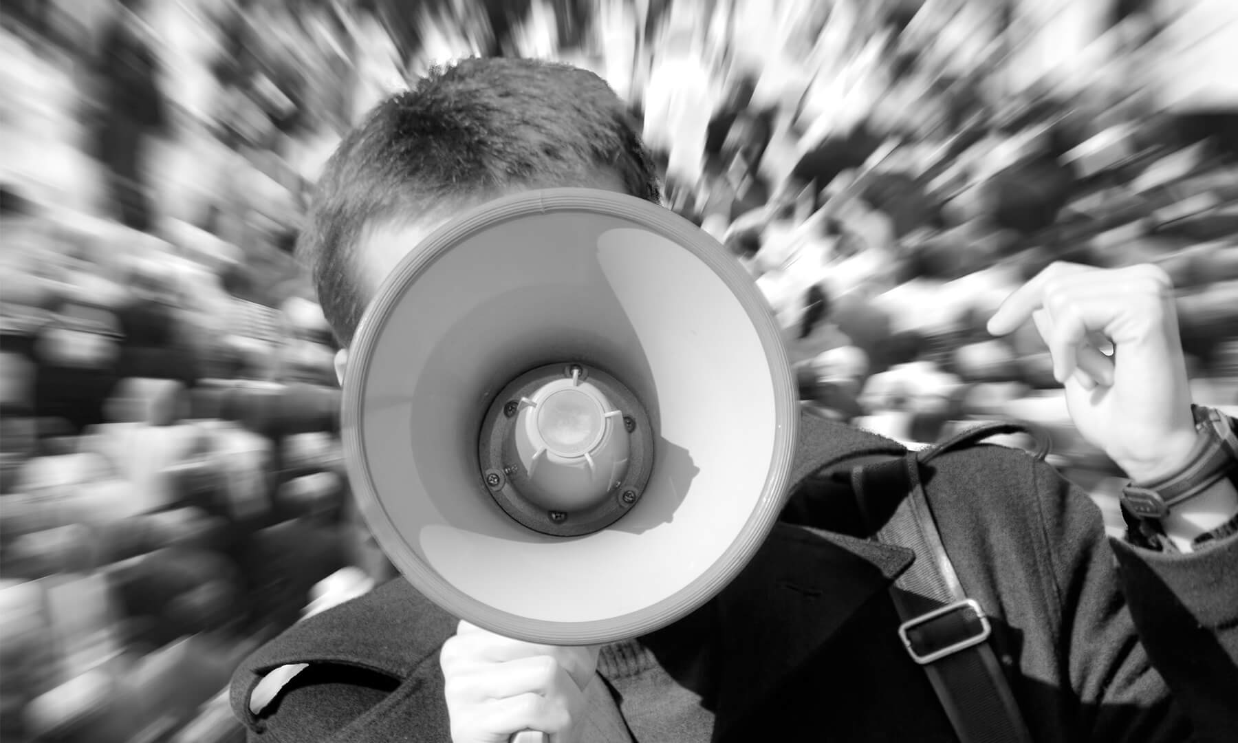 activism - protest - march - teen youth yells through megaphone