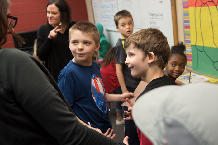 Two students smile