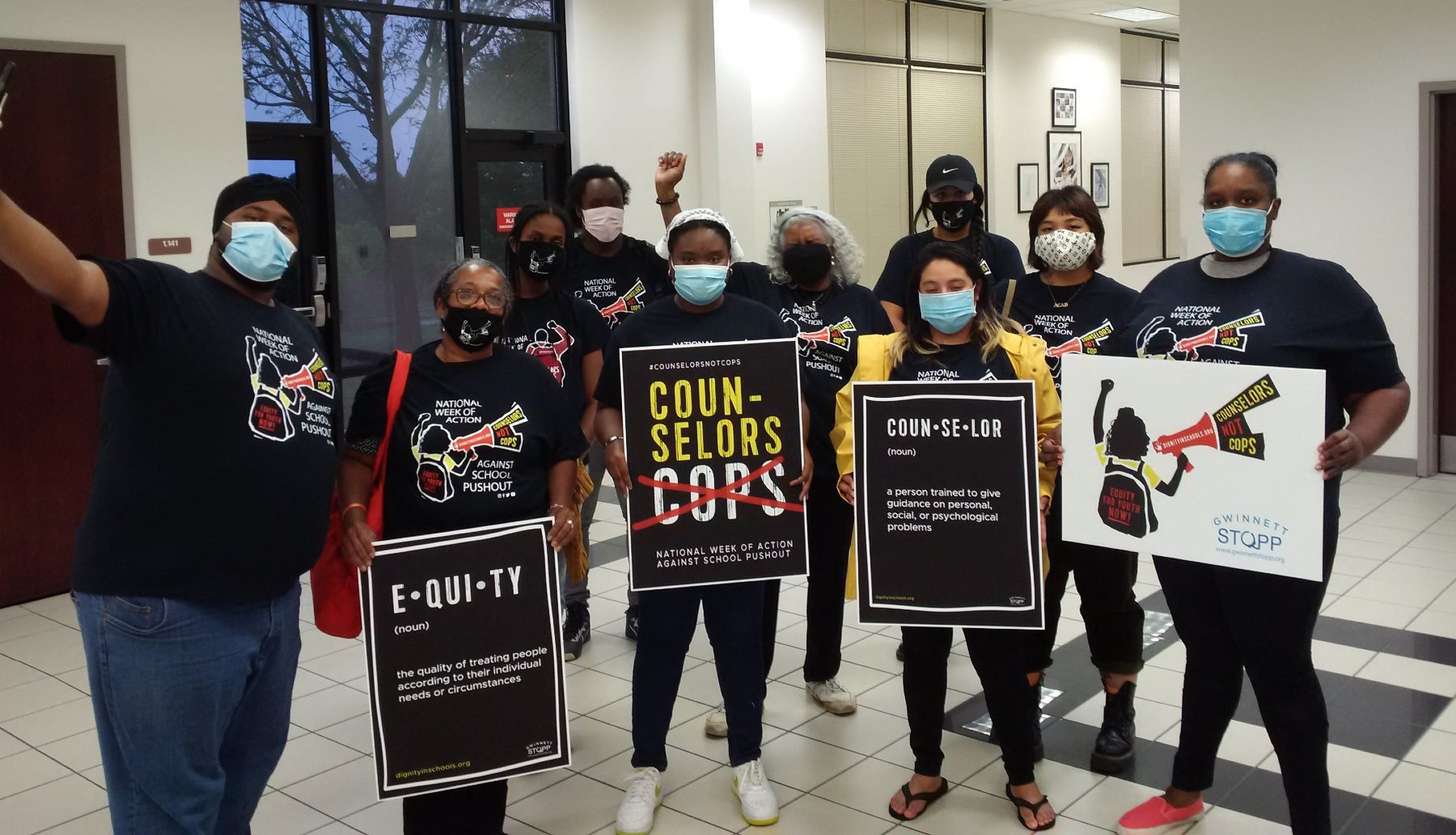 Group of people holding signs.