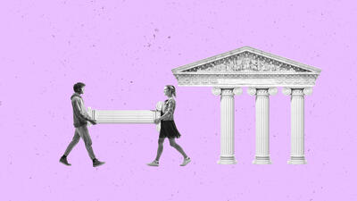 Two people carrying a column to a building