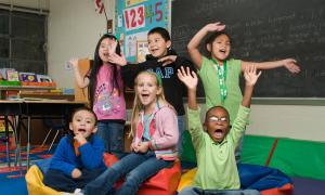 kids posing excitedly in classroom