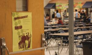 Mix It Up poster at a school cafeteria door, while students eat in the background