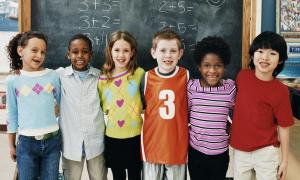 Students hugging in front of chalkboard