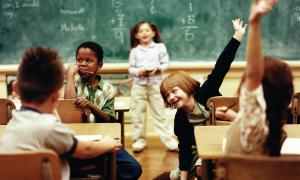 Classroom photo with students raising hands