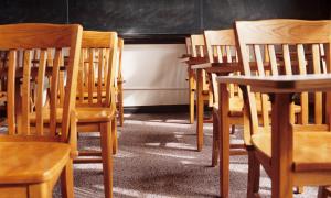 empty wooden desks in classroom
