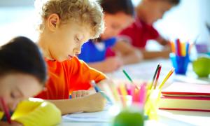 boy coloring at table