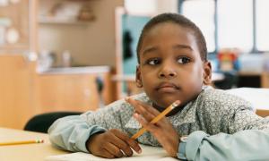 student with pencil thinking