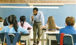 teacher giving instruction to students in class