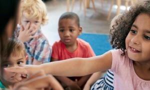 Elementary student pointing at book