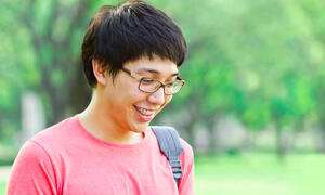 student looking down smiling