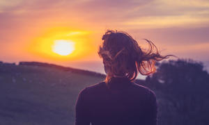 woman looking at sunset