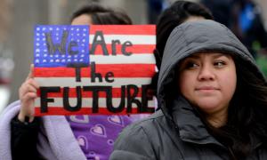 Woman at rally holding sign with caption "We Are the Future"