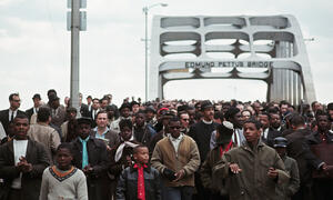 Civil Rights Movement activists marching over the Edmund Pettus Bridge.