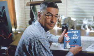 Theodore Seuss Geisel, also known as Dr. Seuss, holding a copy of his book 'The Cat in the Hat'