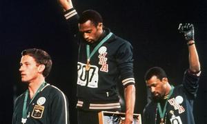 Tommie Smith and John Carlos raise their fists at a 1968 Olympic medal ceremony.