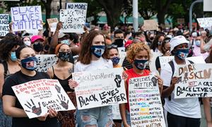 Protesters carrying signs that emphasize "Black Lives Matter."