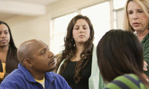 A group of educators speaking to each other.