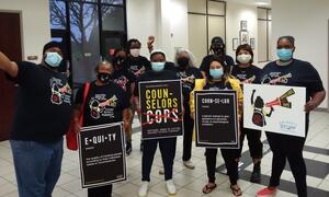 Group of people holding signs.