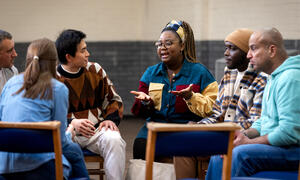 A diverse group of adults meeting in a circle.