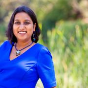 Author Gauri Manglik in blue dress smiling