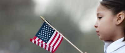 Girl holding small American flag