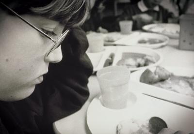 Photo of a student sad, staring at his food plate