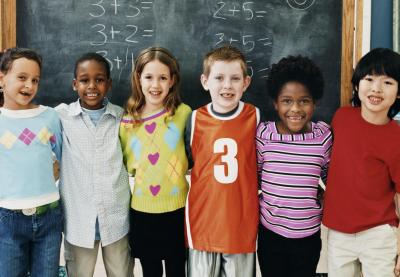 Students hugging in front of chalkboard