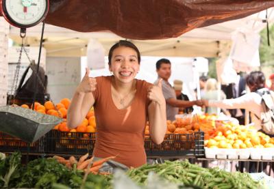 Positive woman in farmer's market