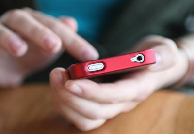 person's hands scrolling through smartphone screen