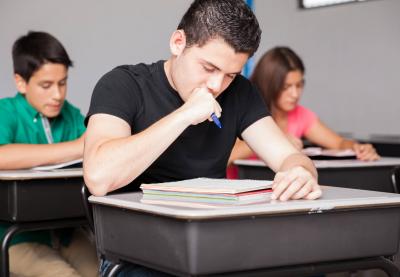 male student working at his desk