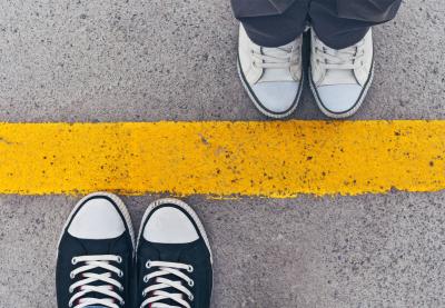 two people standing on yellow line