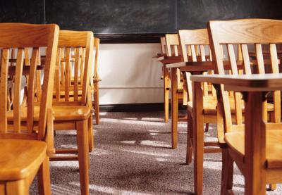 empty wooden desks in classroom