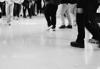 black and white legs walking in hallway