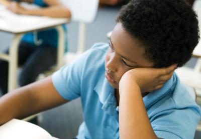 boy reflecting at desk