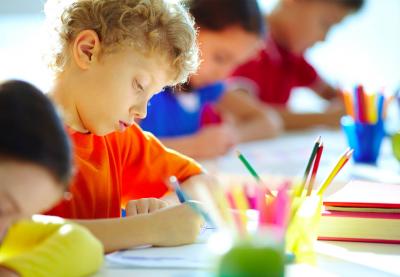 boy coloring at table