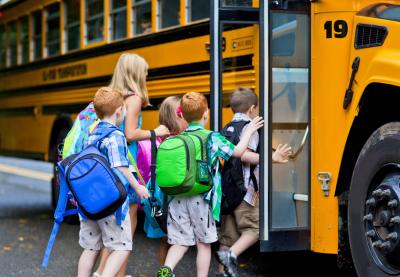 children boarding school bus