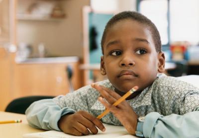 student with pencil thinking