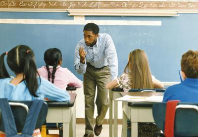 teacher giving instruction to students in class