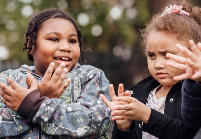 students making butterflies with their hands