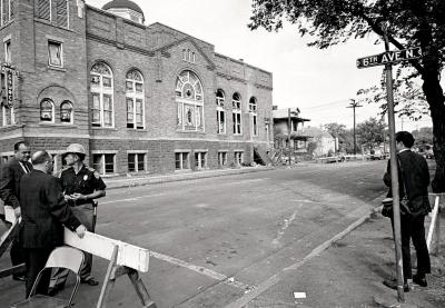 A STATE TROOPER GUARDS A ROAD BLOCK AT THE 16TH STREET BAPTIST CHURCH THE DAY AFTER THE BOMBING.