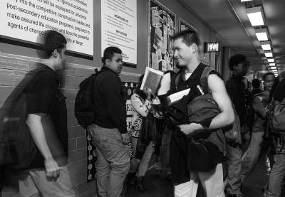 Teaching Tolerance photo of High School hall with Students passing by