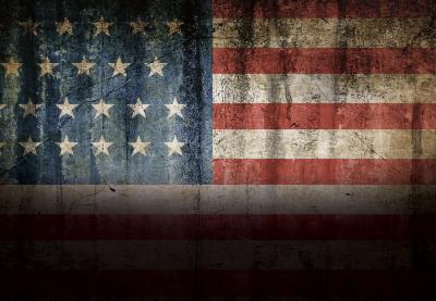 An American flag shrouded in shadow