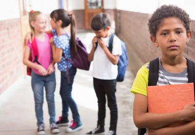 boy standing outside of group of children