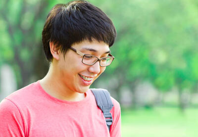 student looking down smiling