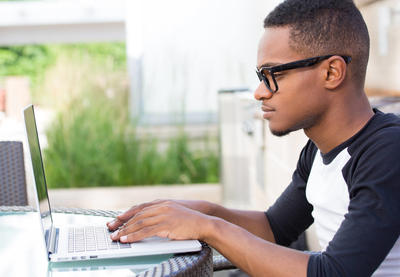 teenage male working at computer