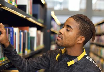 male teenager browsing at library