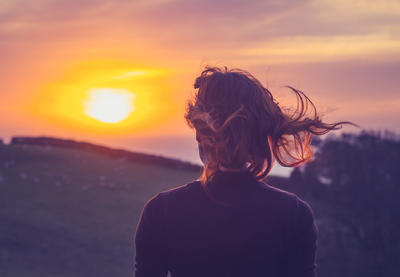 woman looking at sunset