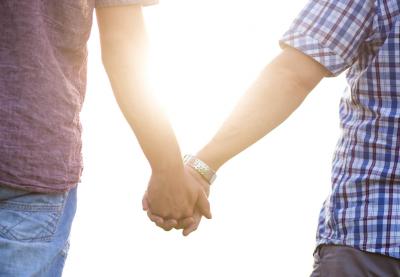 men holding hands in the sunshine