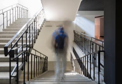 Student walking alone down school hallway